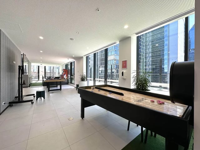 Shuffleboard table gaming tables large windows lounge area at The Switch Melbourne Victoria Market in Melbourne Student Accommodation