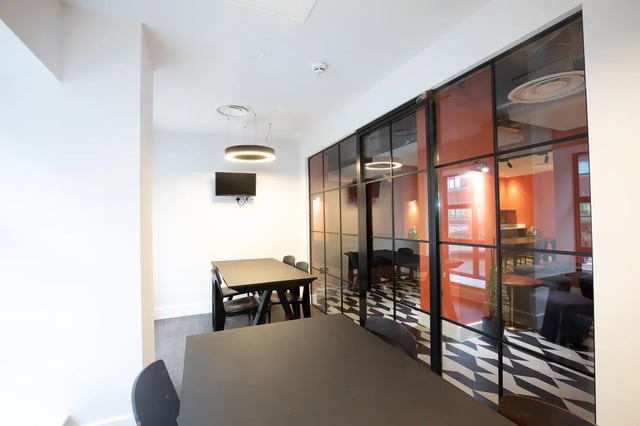 Tables chairs and television common area at Collegiate Nova in Nottingham Student Accommodation
