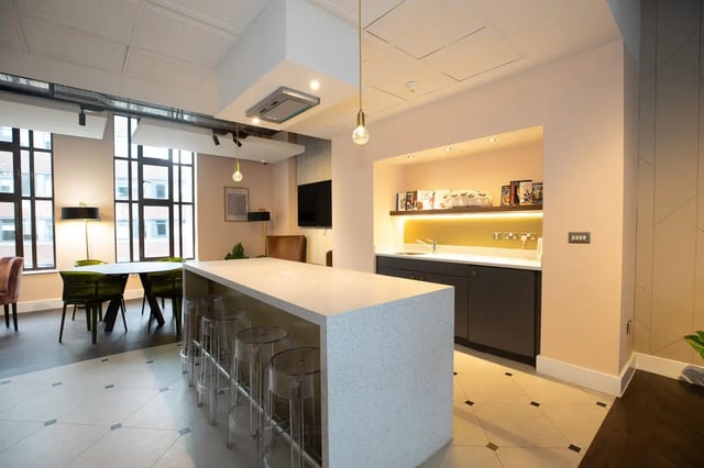 Island bar stools dining table kitchen area living room at Collegiate Nova in Nottingham Student Accommodation