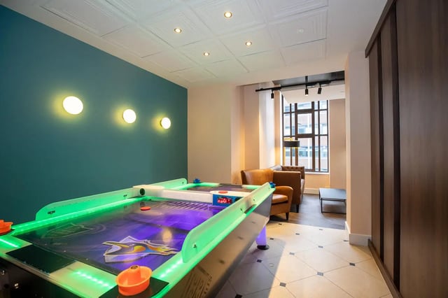 Air hockey table leather chairs coffee table lounge area at Collegiate Nova in Nottingham Student Accommodation