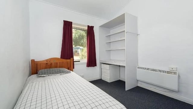 Bed shelving unit and heater bedroom. at UniLodge Wodonga East End in Wodonga Student Accommodation
