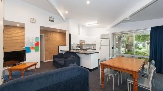 Sofas kitchen table and chairs living room at UniLodge Wodonga East End in Wodonga Student Accommodation
