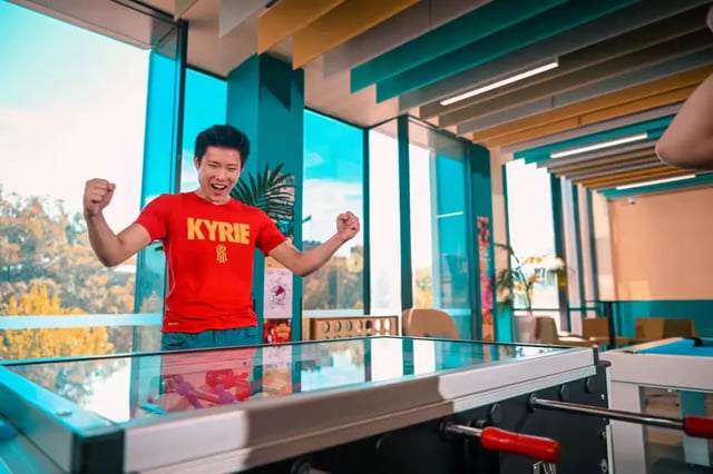 Man celebrating by foosball table playing area at Scape Adelaide University in Adelaide Student Accommodation