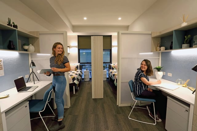 Beds desks and students in shared accommodation bedroom at Scape Adelaide University in Adelaide Student Accommodation