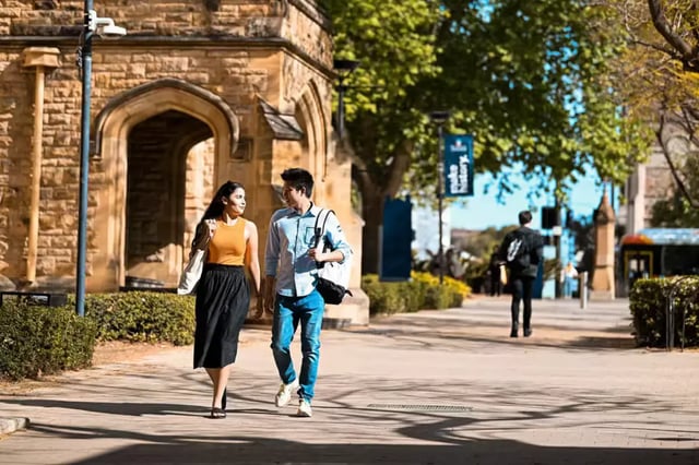 Students walk past historic building exterior at Scape Adelaide University in Adelaide Student Accommodation