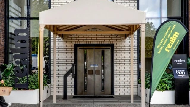 Double doors under awning with signage exterior at Realm Caulfield in Melbourne Student Accommodation