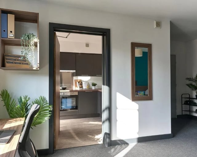 Desk chair, shelving, kitchen, mirror Interior view at Cavendish Place in Manchester Student Accommodation