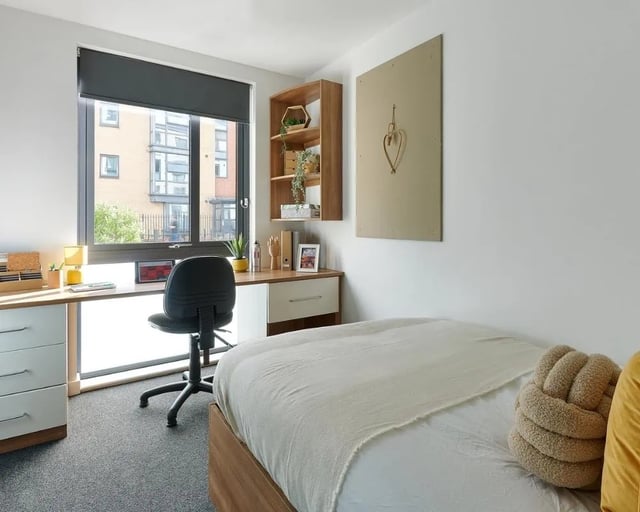 Desk chair bed shelves and window bedroom at Cavendish Place in Manchester Student Accommodation