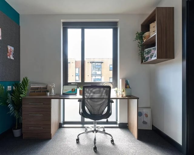 Desk with chair laptop and plant study area at Cavendish Place in Manchester Student Accommodation