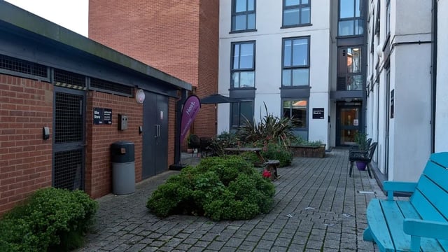 Courtyard with bike store picnic tables chairs exterior at Cavendish Place in Manchester Student Accommodation
