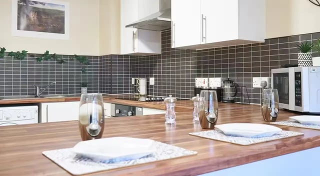 Countertop with glasses plates appliances and decor kitchen at Oxney House & Gardens in Manchester Student Accommodation