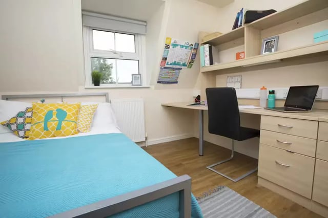 Bed desk chair shelves laptop and pillows bedroom at Oxney House & Gardens in Manchester Student Accommodation