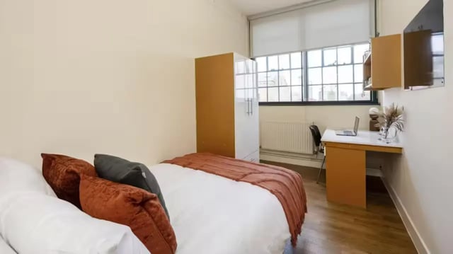 Bed wardrobe desk laptop and window bedroom at Nottingham Square in Nottingham Student Accommodation