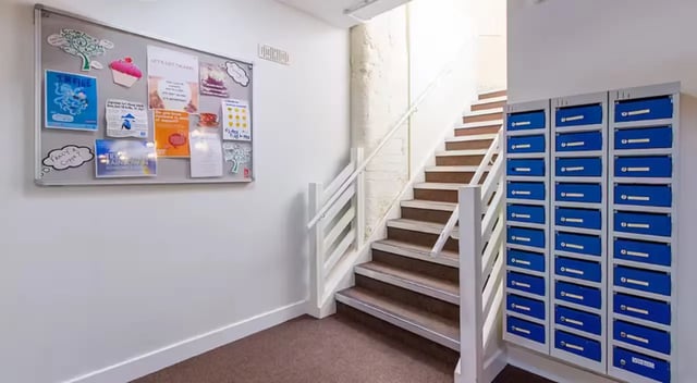 Bulletin board mailboxes and stairs communal area at Nottingham Square in Nottingham Student Accommodation