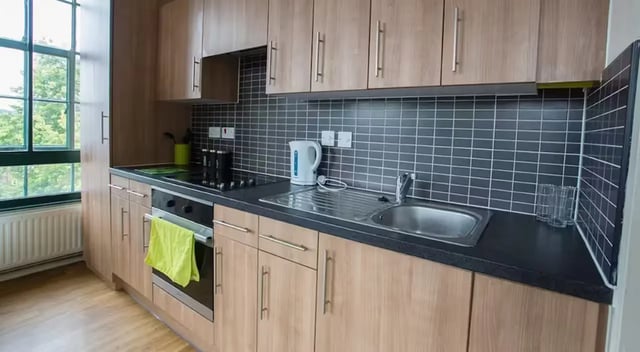 Modern kitchen with wooden cabinets sink kettle kitchen at Nottingham Square in Nottingham Student Accommodation