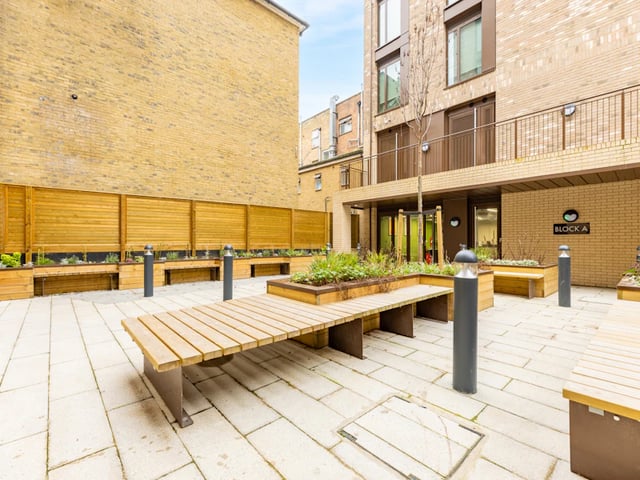 Wooden benches planters lights Block A exterior at Venue Studios in London Student Accommodation