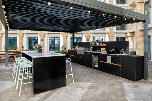 Outdoor kitchen with bar and grill patio area at Wick Park in London Student Accommodation