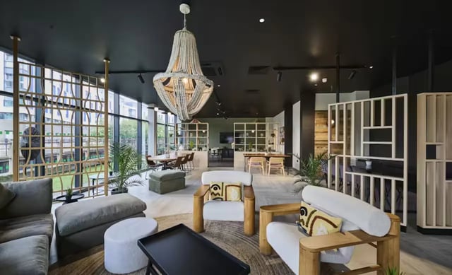 Modern lounge area with seating and tables Living room at Nottingham Two in Nottingham Student Accommodation