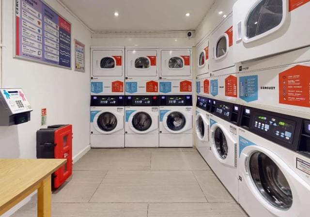 Washing machines and dryers clean laundry room at iQ Tufnell House in London Student Accommodation