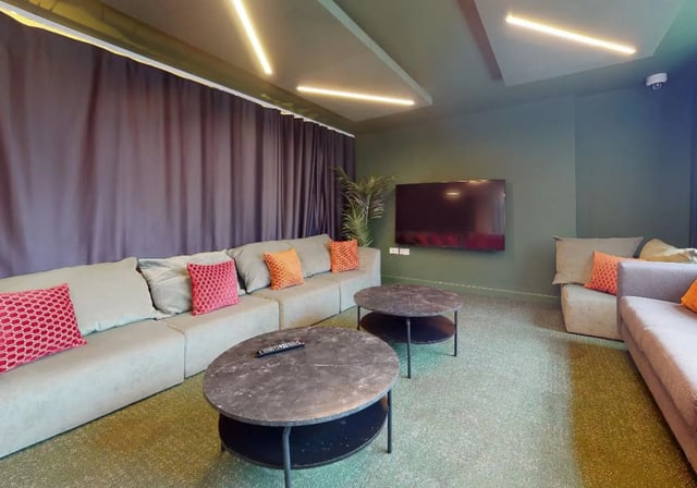 Sofa with pillows coffee tables and TV living room at iQ Tufnell House in London Student Accommodation