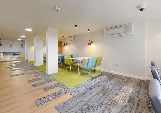 Tables and chairs in communal area at iQ Tufnell House in London Student Accommodation