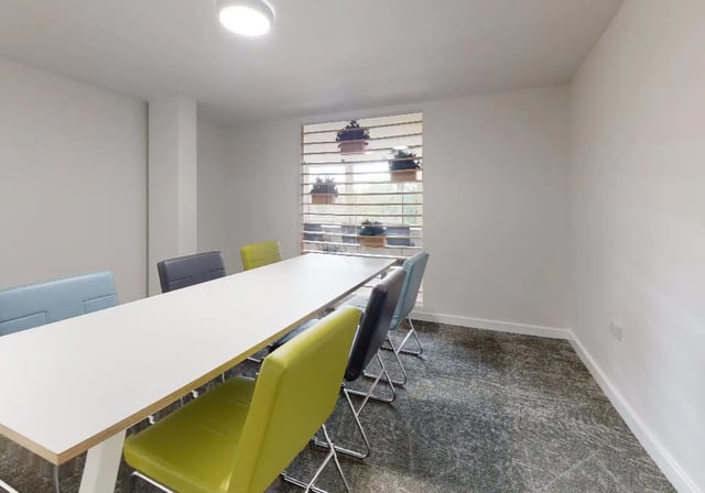 Meeting room with long table and colorful chairs at iQ Tufnell House in London Student Accommodation