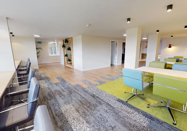Chairs and tables with plants communal area at iQ Tufnell House in London Student Accommodation