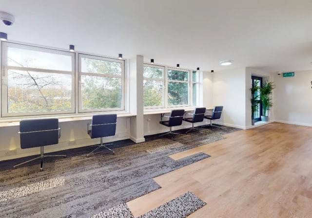 Chairs by windows and plant near door common area at iQ Tufnell House in London Student Accommodation