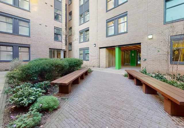 Courtyard with benches and greenery exterior at iQ Tufnell House in London Student Accommodation