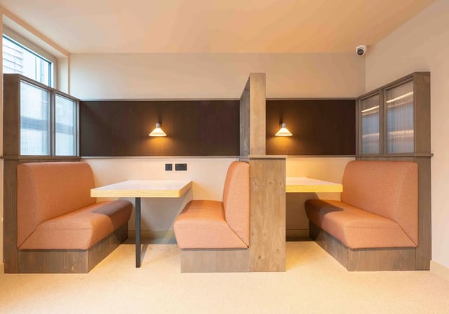 Booth seating with tables and lights study area at iQ Paris Gardens in London Student Accommodation