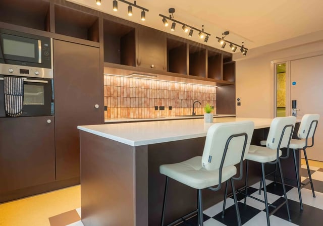 Modern kitchen with island seating oven microwave kitchen. at iQ Paris Gardens in London Student Accommodation