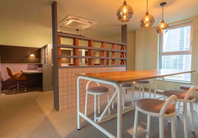 Table with stools study area and partition study at iQ Paris Gardens in London Student Accommodation