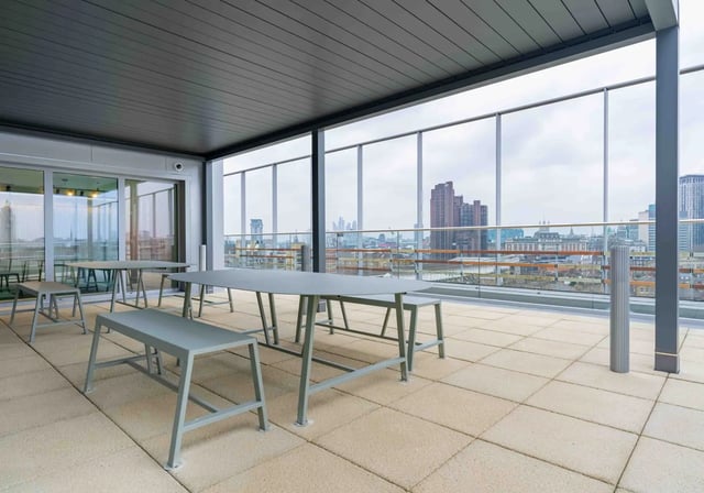 Tables and benches on rooftop terrace playing area at iQ Paris Gardens in London Student Accommodation
