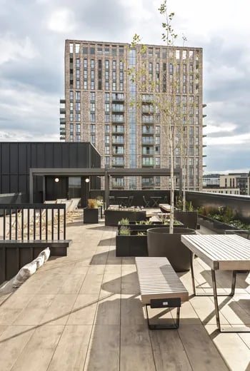 Rooftop seating area with benches and planters exterior at ARK Wembley in London Student Accommodation