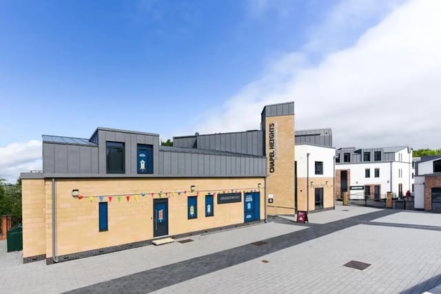 Modern student accommodation building with colourful flags exterior at Chapel Heights in Durham Student Accommodation