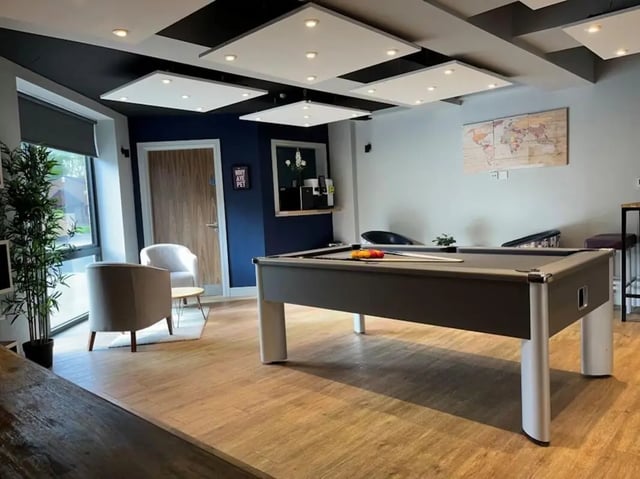 Pool table lounge area with chairs and plants Living room at Chapel Heights in Durham Student Accommodation