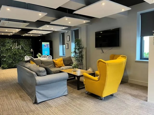 Grey sofa yellow chair coffee table living room at Chapel Heights in Durham Student Accommodation