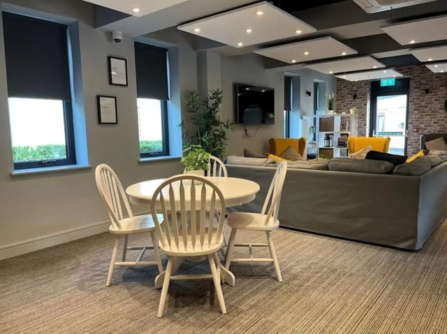 White table chairs and grey sofa living room at Chapel Heights in Durham Student Accommodation