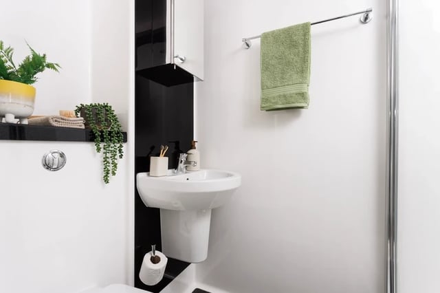 Sink toiletries green towel toilet roll bathroom at Houghall Court in Durham Student Accommodation