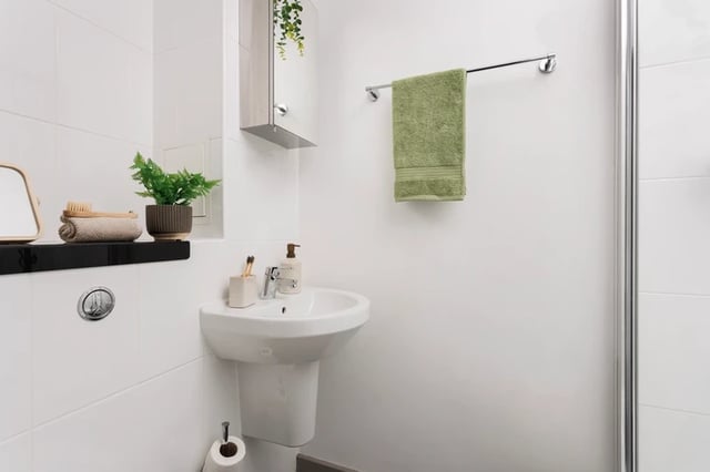 Sink with green towel and plant bathroom at Houghall Court in Durham Student Accommodation