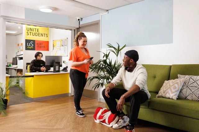 Reception desk people talking couch living area at Elvet Studios in Durham Student Accommodation