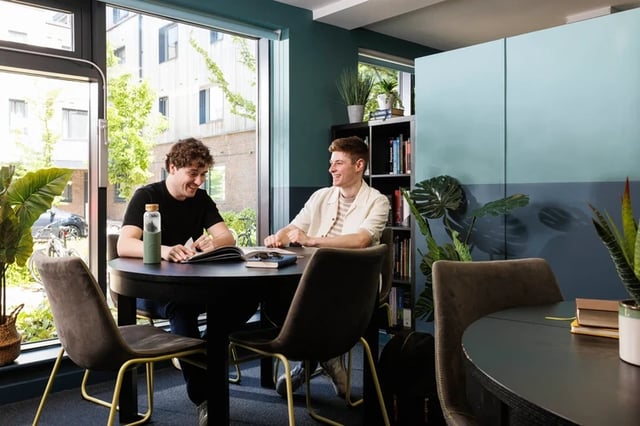 Two students at table studying common area at Elvet Studios in Durham Student Accommodation