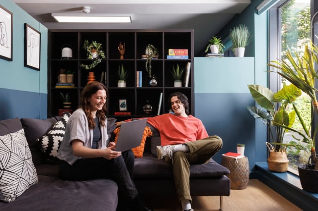 Two students on sofa with laptop living room at Elvet Studios in Durham Student Accommodation