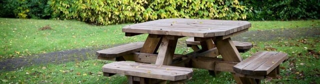 Wooden picnic table on grass playing area at Weston Court in Manchester Student Accommodation