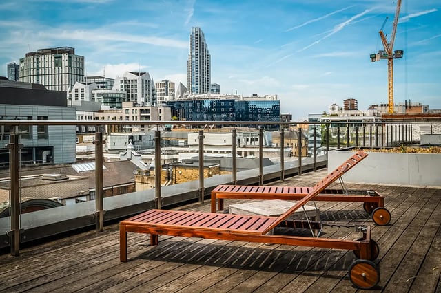 Wooden lounge chairs on rooftop exterior at Chapter Old Street in London Student Accommodation