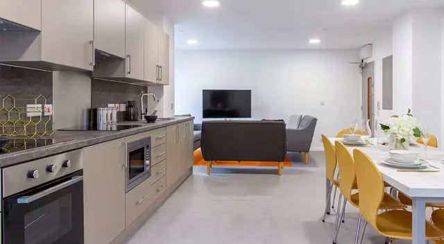 Kitchen living area with dining table and chairs living room at Dean Street Works in Bristol Student Accommodation
