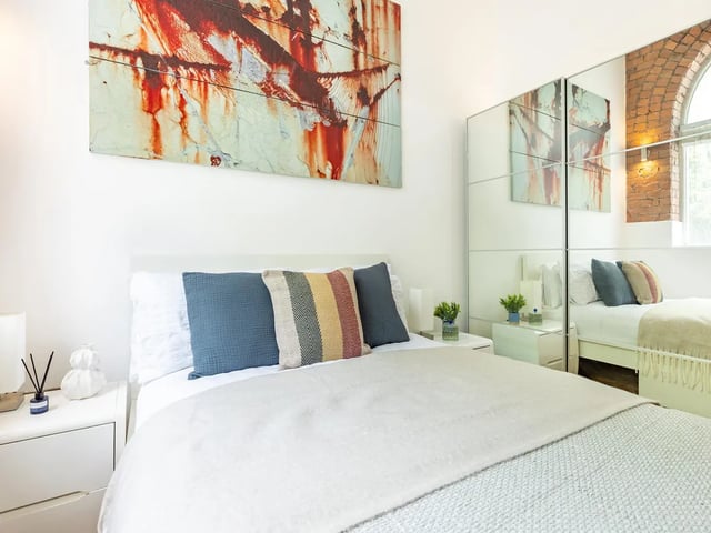 Bed with colorful pillows and art bedroom at Ashton House in Manchester Student Accommodation