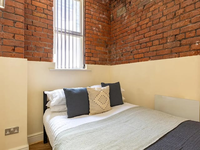 Bed with pillows and blankets bedroom at Ashton House in Manchester Student Accommodation