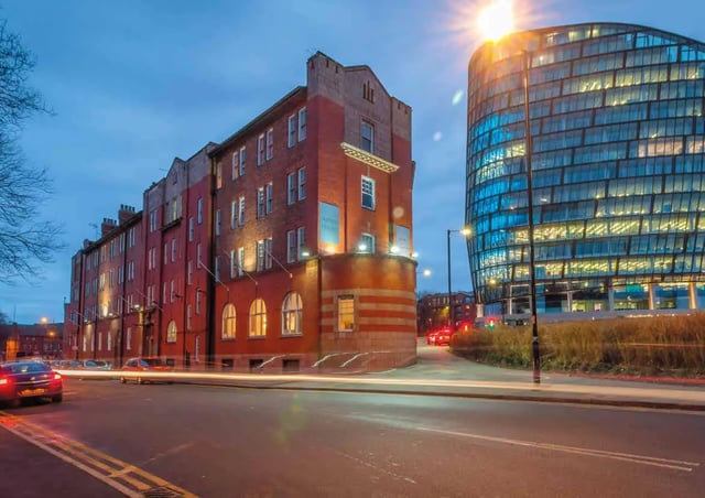 Brick apartment buildings with modern glass building exterior at Ashton House in Manchester Student Accommodation