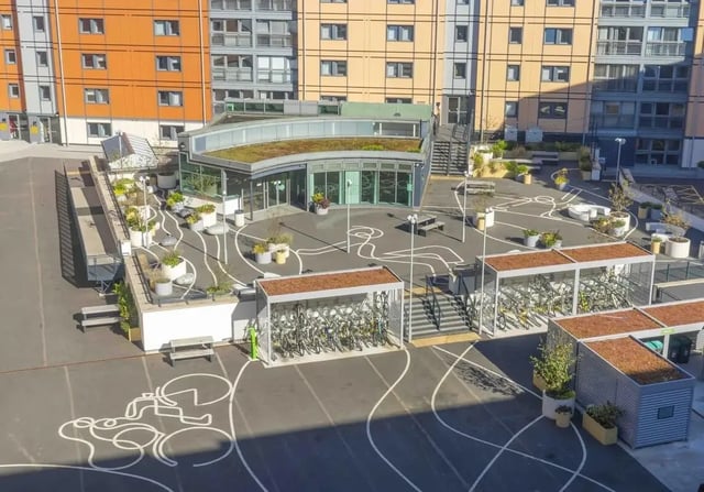Courtyard with seating bike racks and landscaping exterior at iQ Kerria Apartments in Manchester Student Accommodation